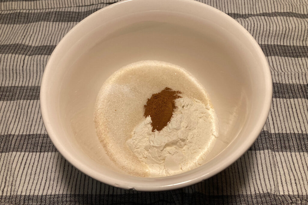 Dry ingredients for apple crisp topping in white ceramic bowl