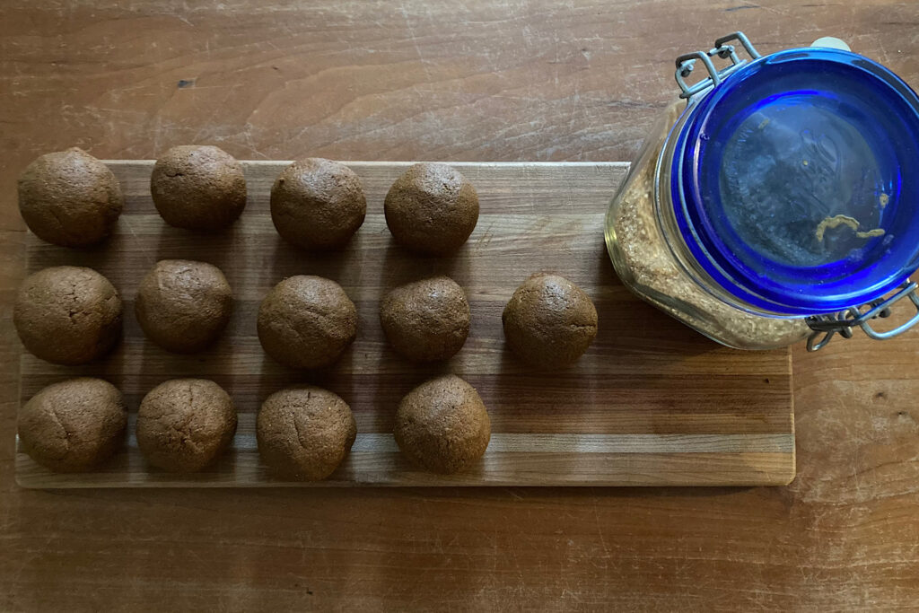 Rolled dough ball ornaments on cutting board