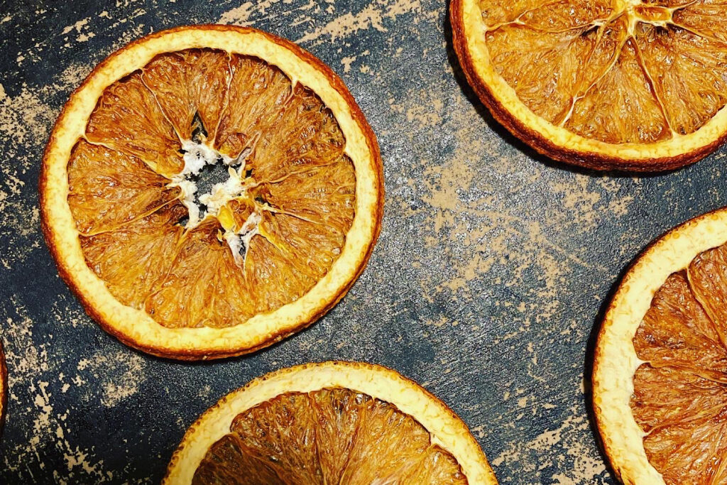 Stone-dried orange slices on pizza stone