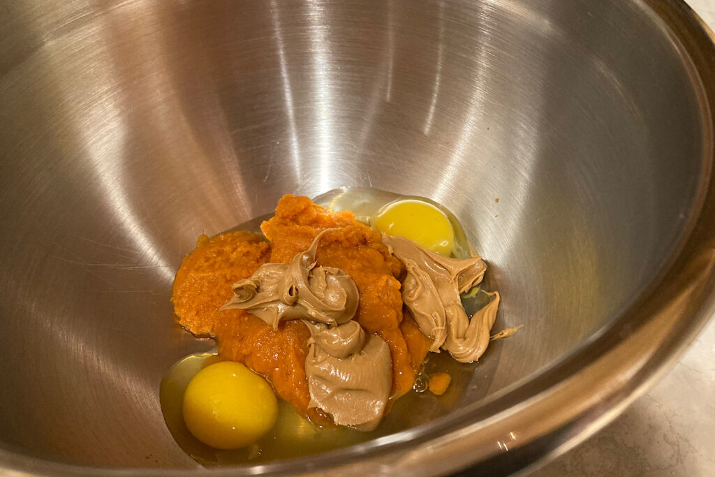 Eggs, Peanut Butter, and pumpkin in mixing bowl