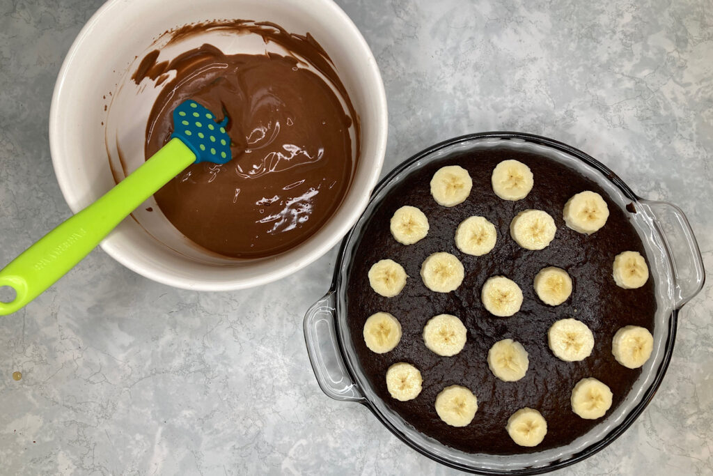 Frosting and Banana Slices on Chocolate Cake