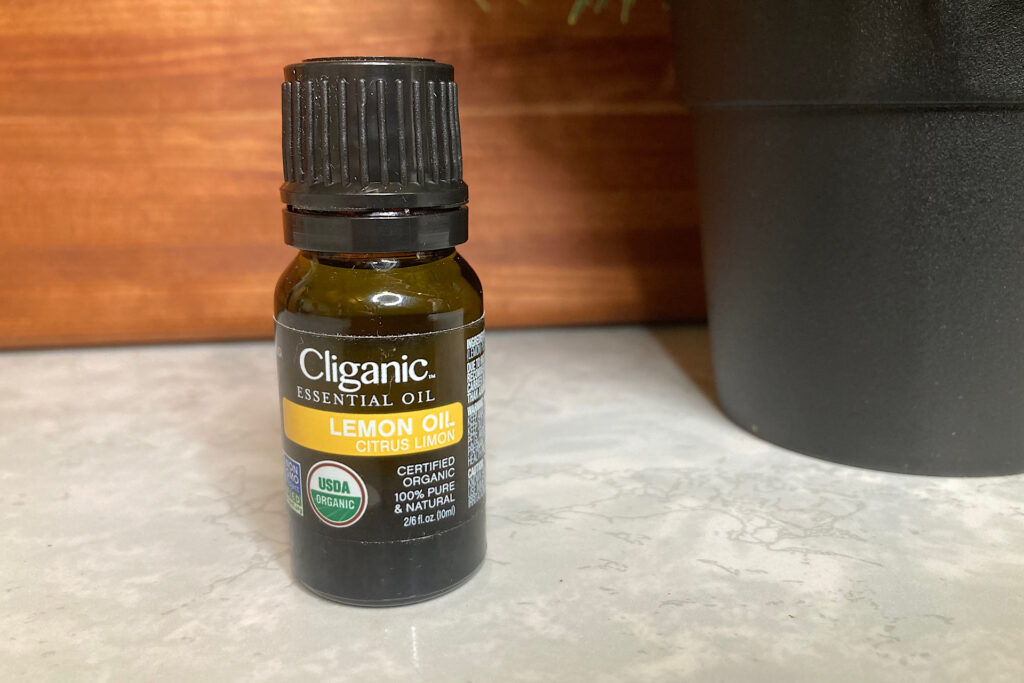 Cliganic Lemon Essential Oil bottle used for Grain Alcohol Spray Sanitizer