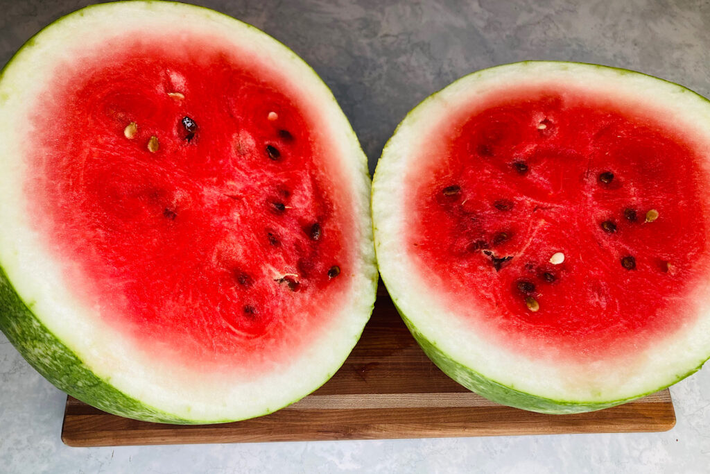 Halved Watermelon on Wooden Cutting Board