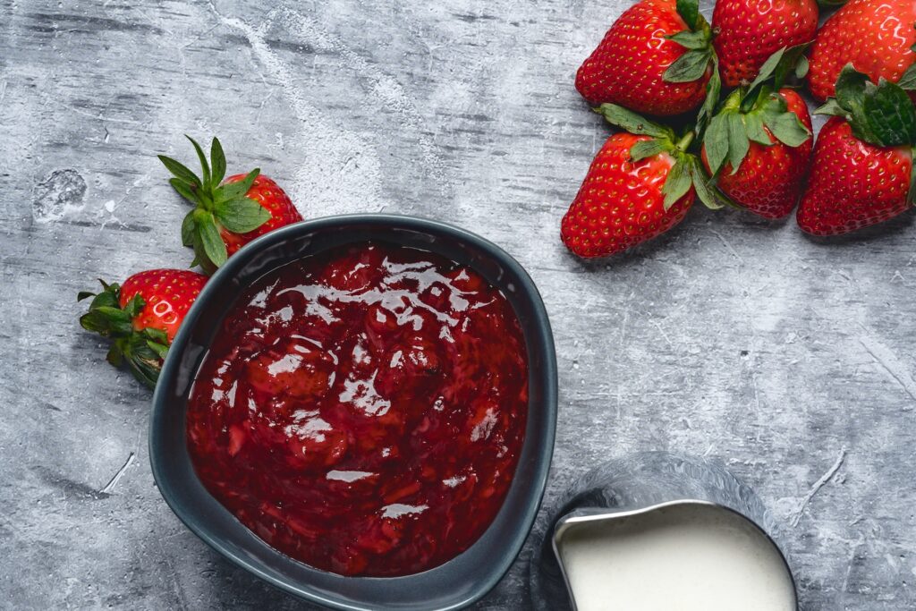 Strawberry Jam - Beginner Recipe in Bowl with fresh strawberries and cream