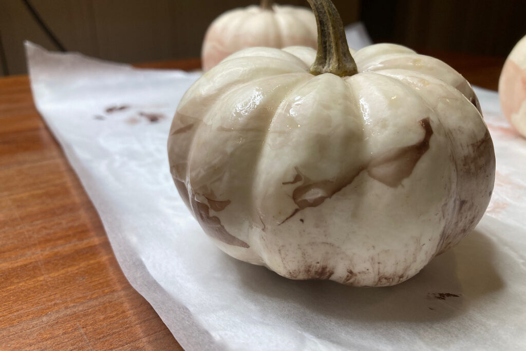 Enamel-dipped pumpkin in chocolate tone.