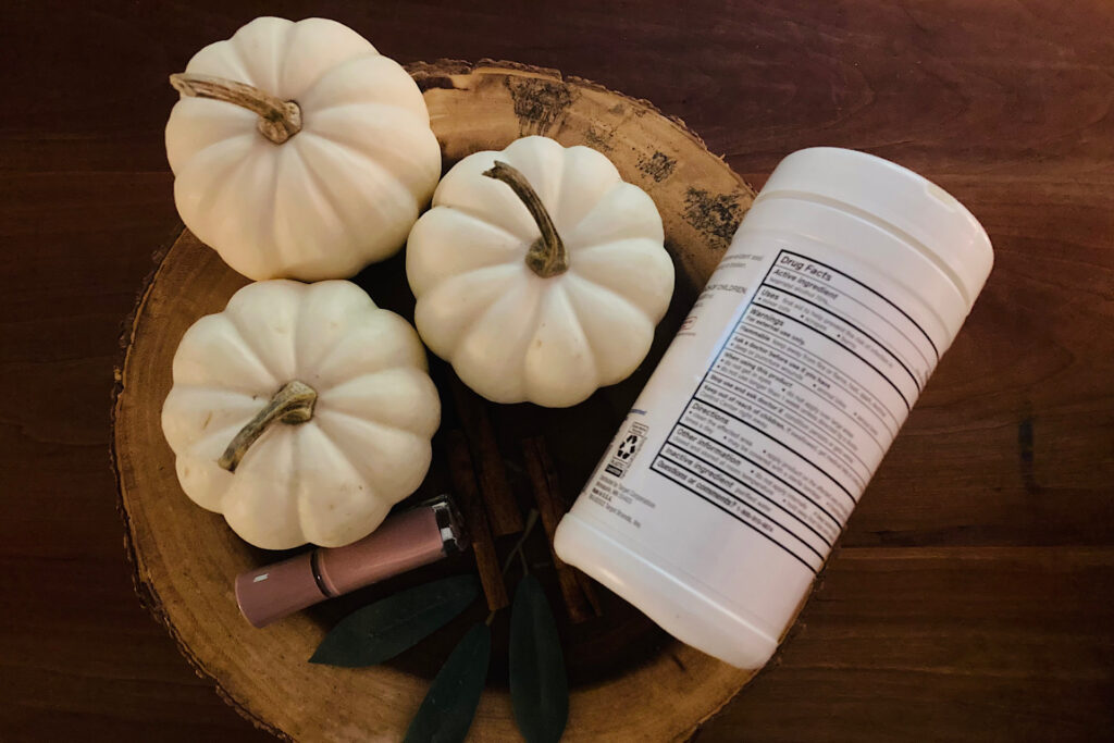 White pumpkins, nail enamel and alcohol wipe supplies for crafting.