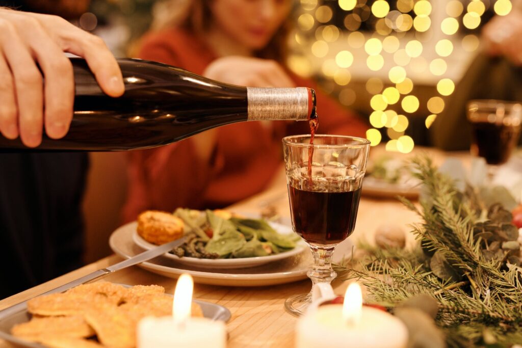 Holiday table, man pouring wine