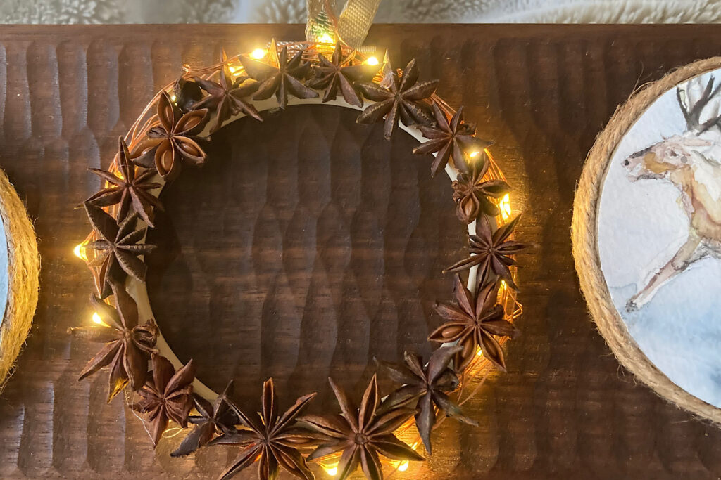 Lit Anise Star Wreath and Watercolor Reindeer Ornament