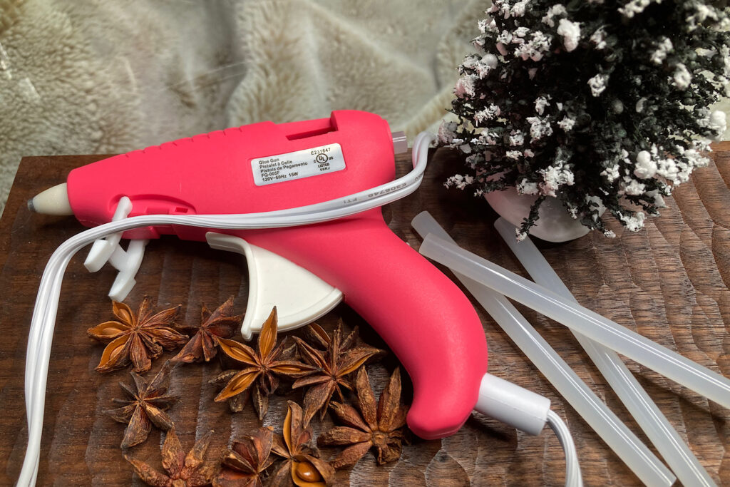 Pink Hot Glue Gun with sticks and Anise Seeds