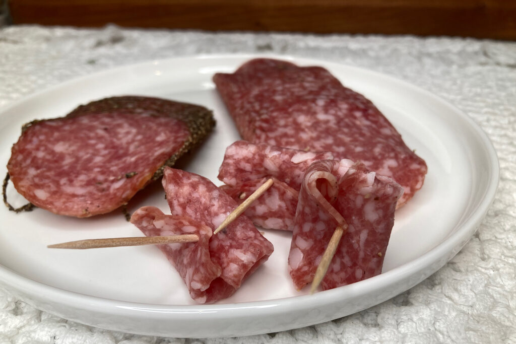 Salami on Toothpicks on White Plate