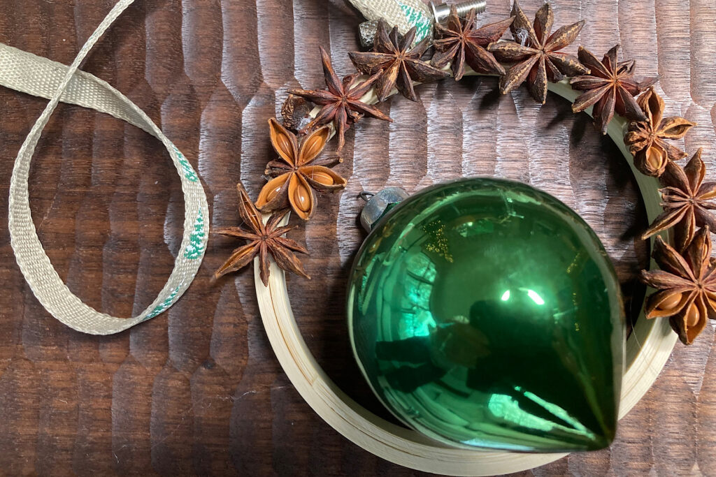 Star Anise Seeds Glued Half Way Around Embroidery Hoop with Christmas Bulb