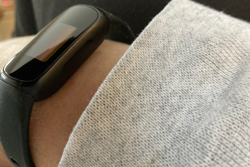 Fitbit on wrist with sweatshirt sleeve