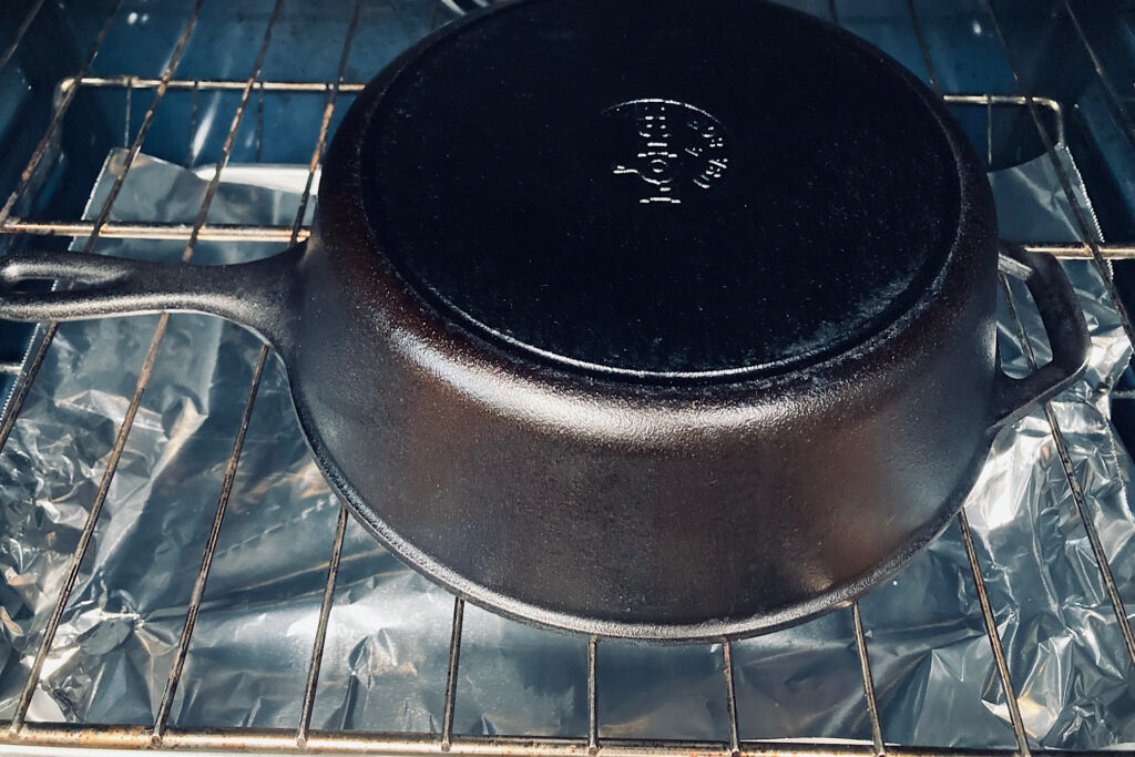 seasoned cast iron pan on oven rack