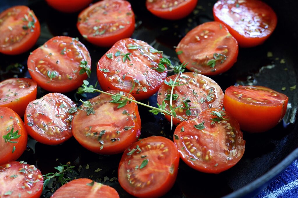 cherry tomatoes and seasoning in cast iron