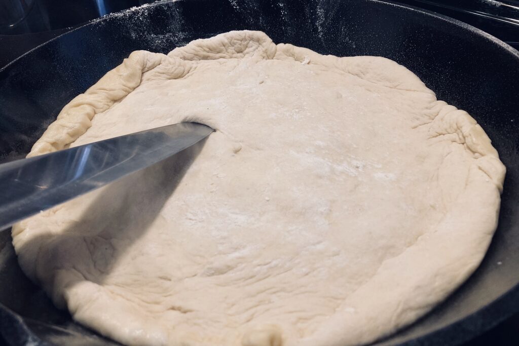 piercing crust in cast iron skillet with knife tip