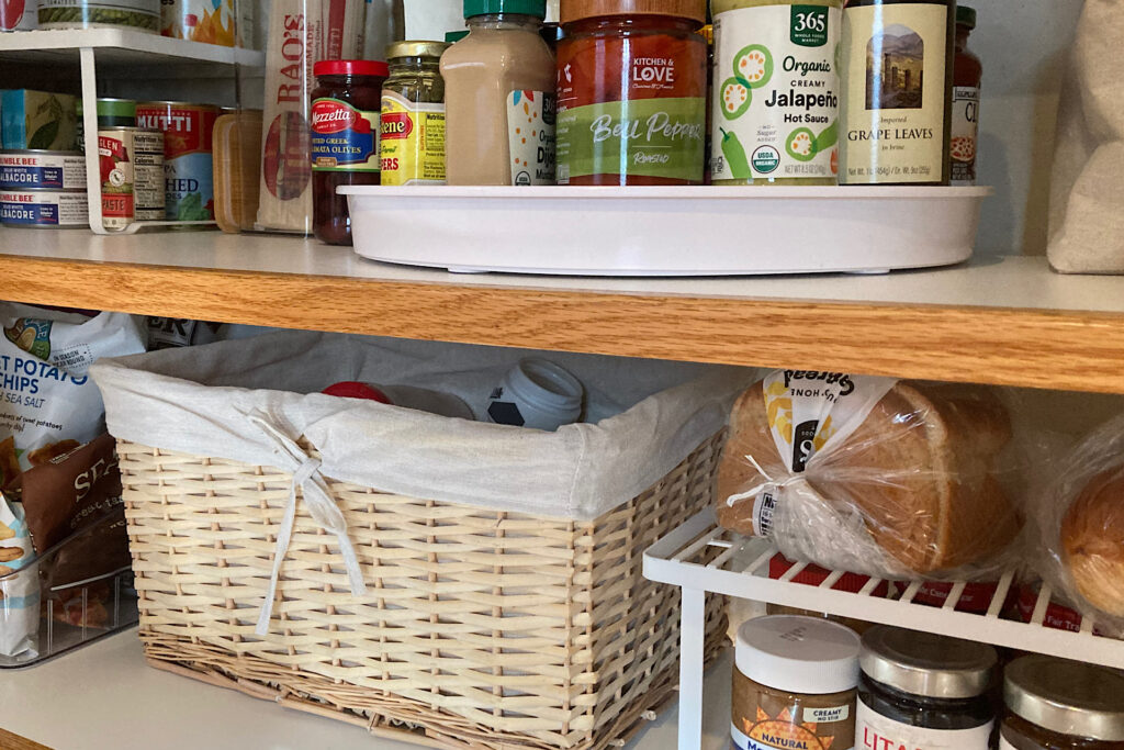 stacking tray, lazy susan and basket for pantry organization