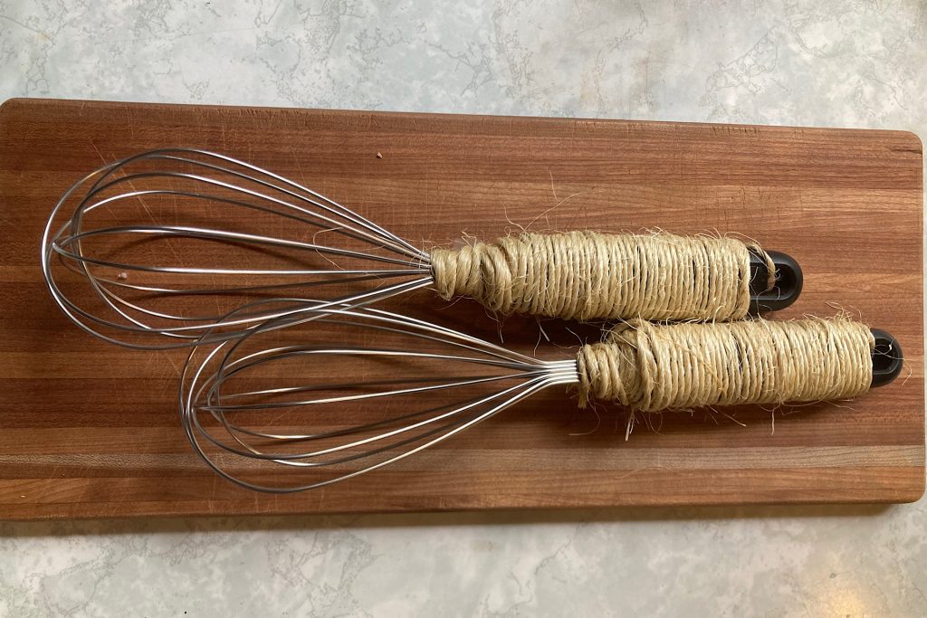 twine wrapped around two whisk handles
