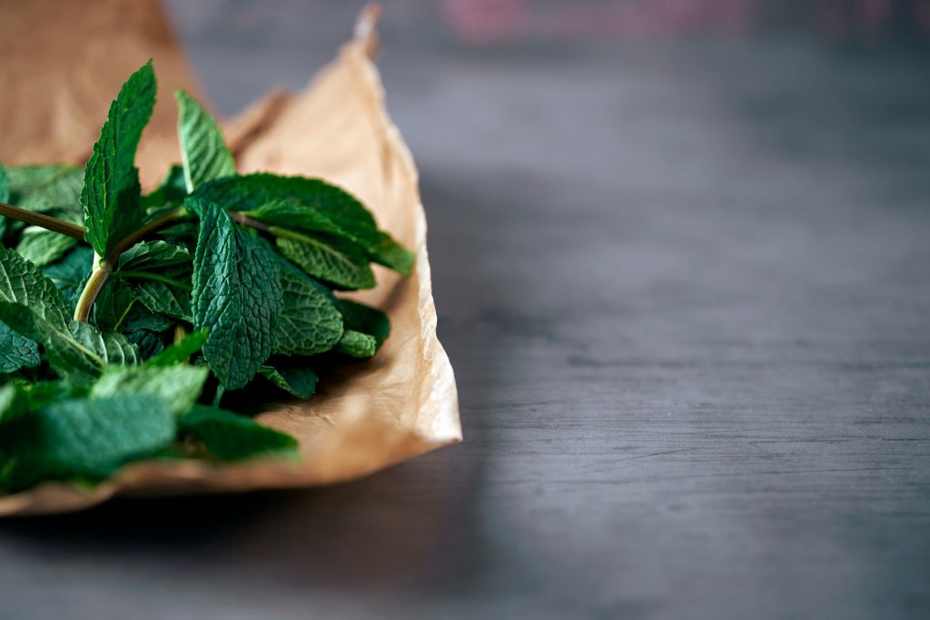 mint sprigs on paper bag