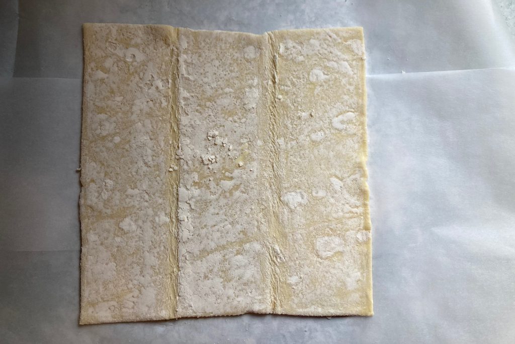 raw puff pastry on parchment paper