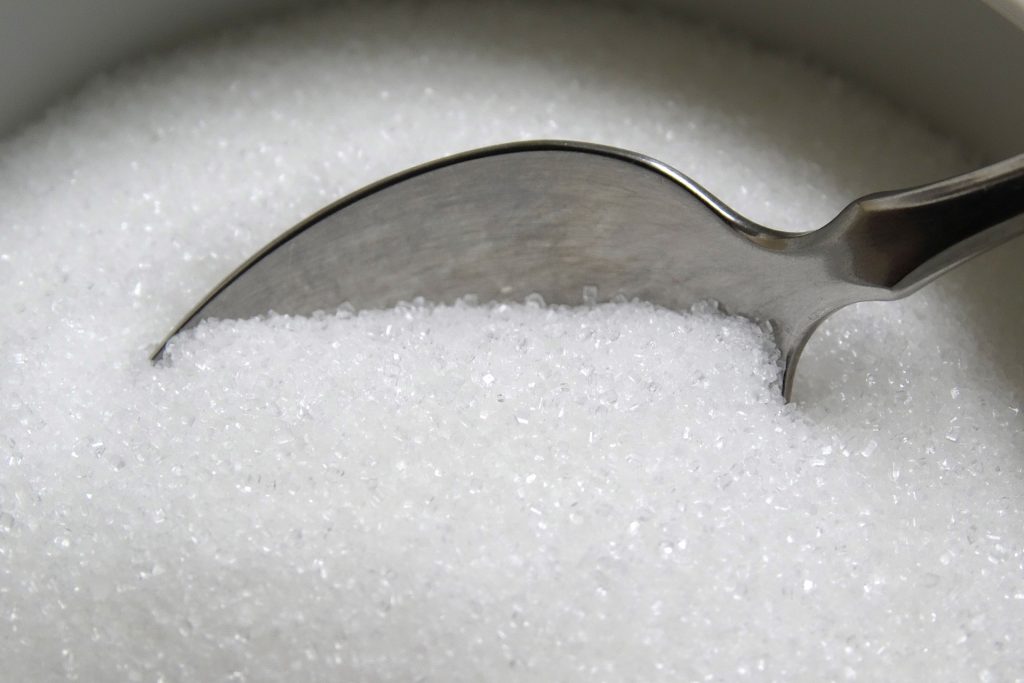 closeup of teaspoon in sugar bowl