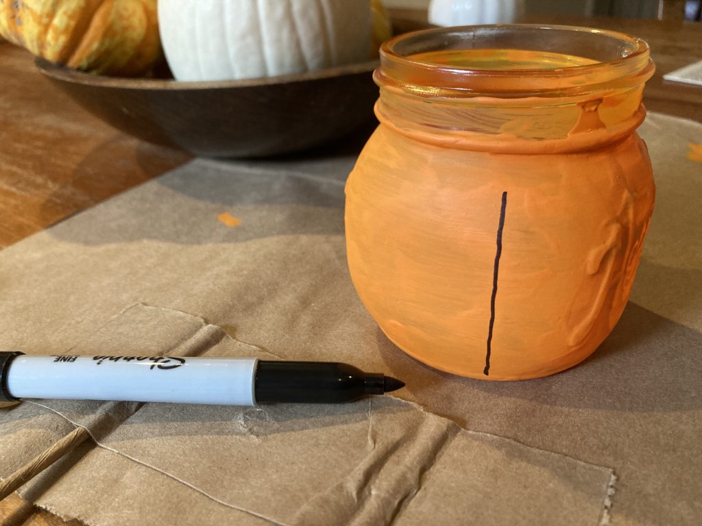 Drawing vine line on Fall mason jar pumpkin lantern