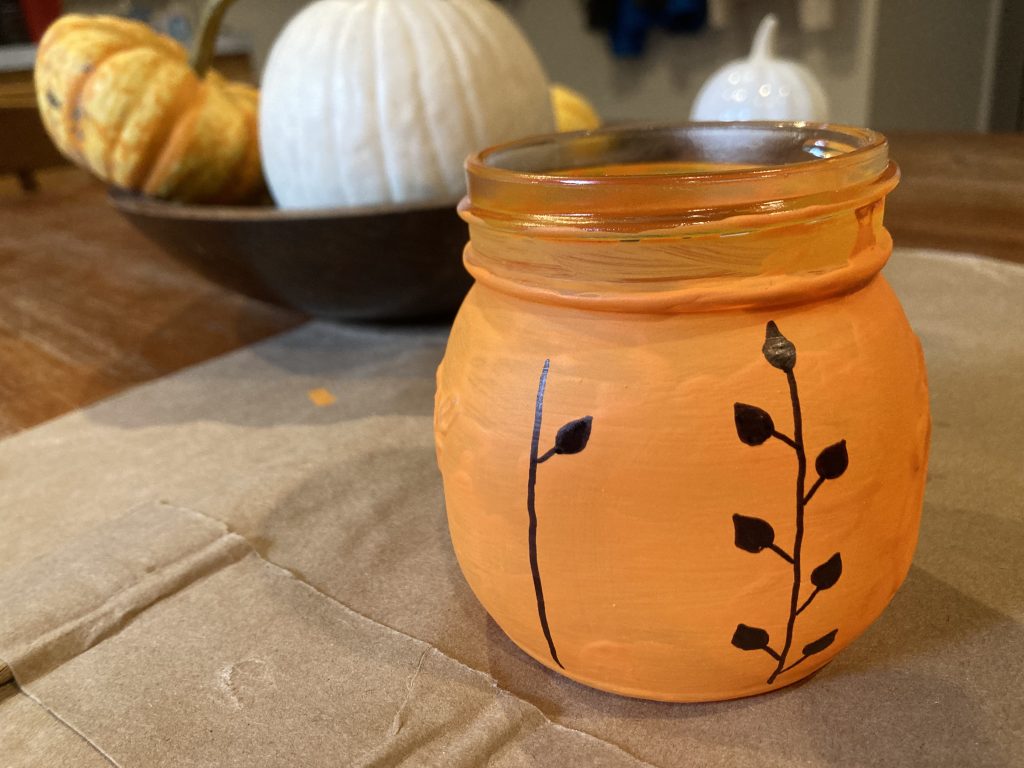 Drawing additional vines on pumpkin mason jars