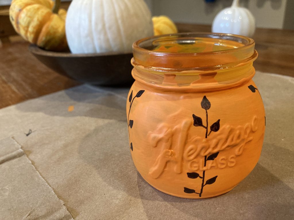 Drawing vine on pumpkin through mason jar logo