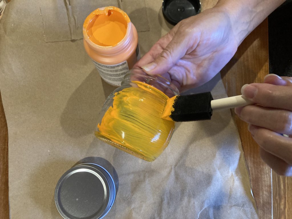 First coat of paint on fall mason jar pumpkin lantern