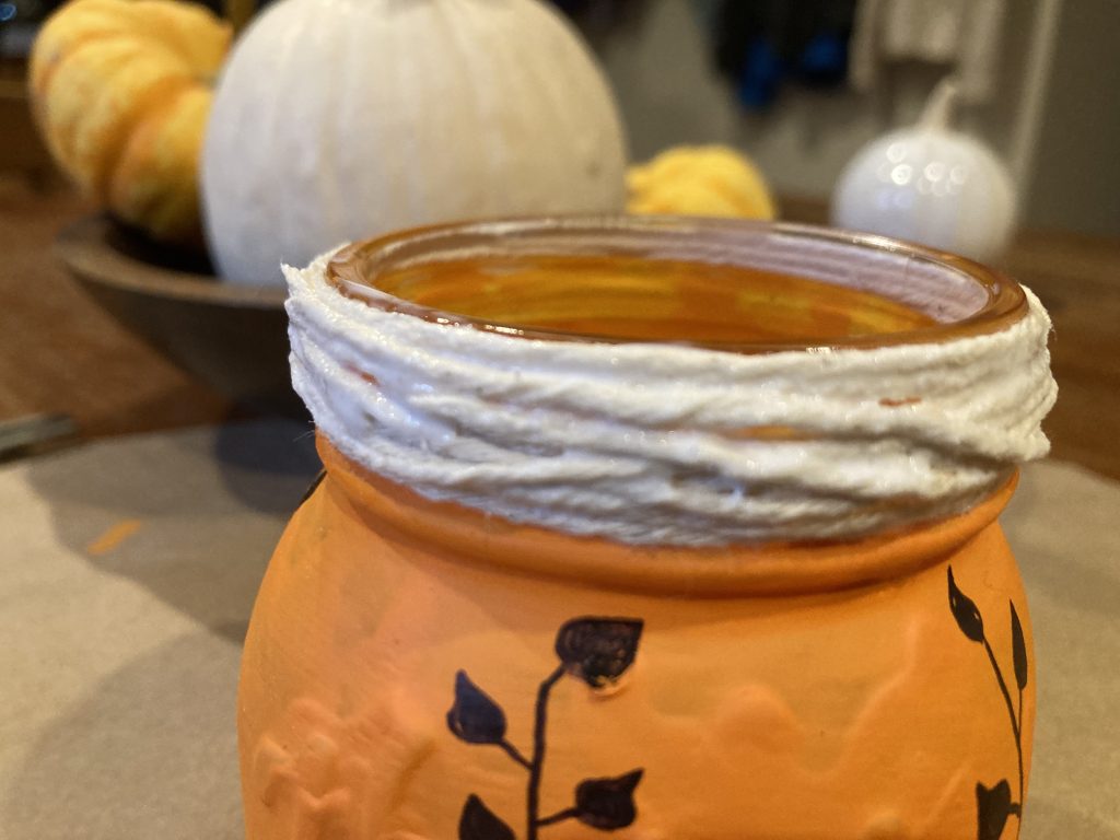 Mod Podge twine of mouth of Fall mason jar pumpkin lantern