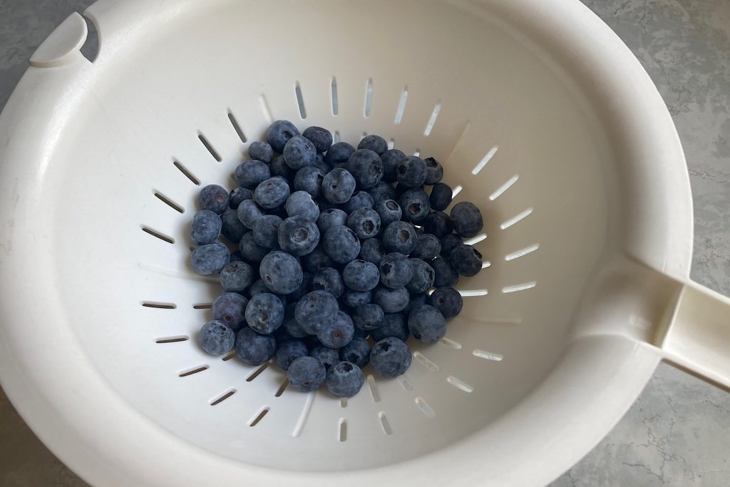 blueberries in white colander