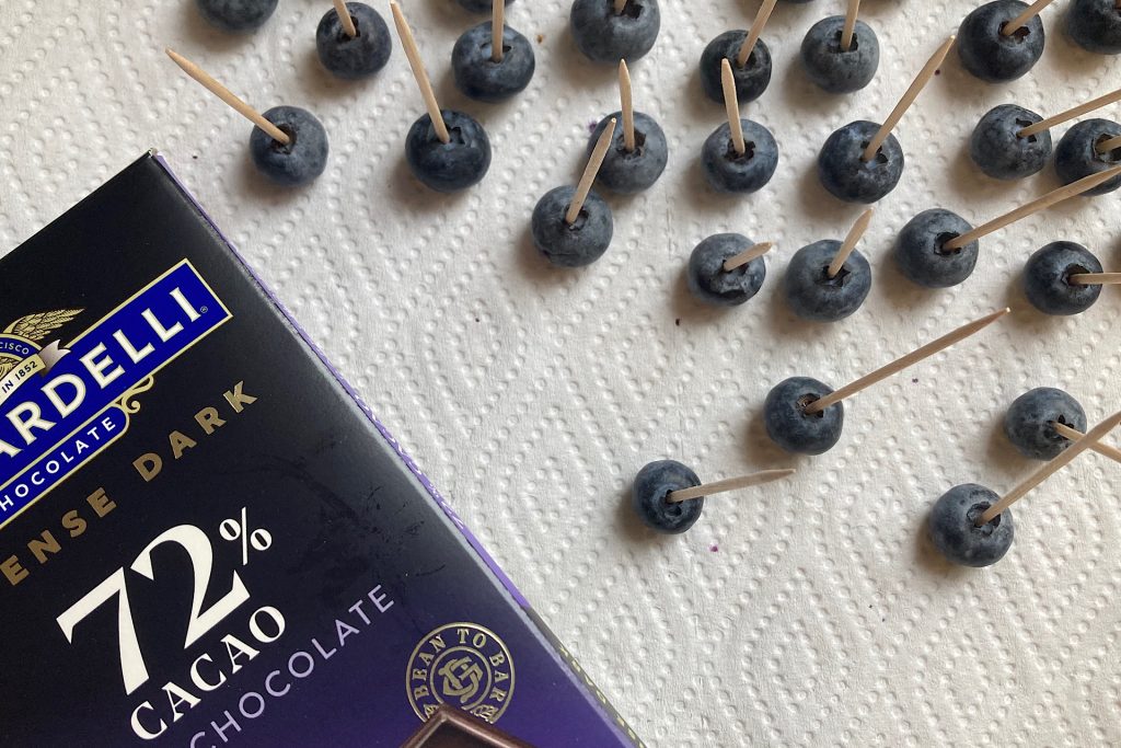 blueberries with toothpicks and chocolate bar