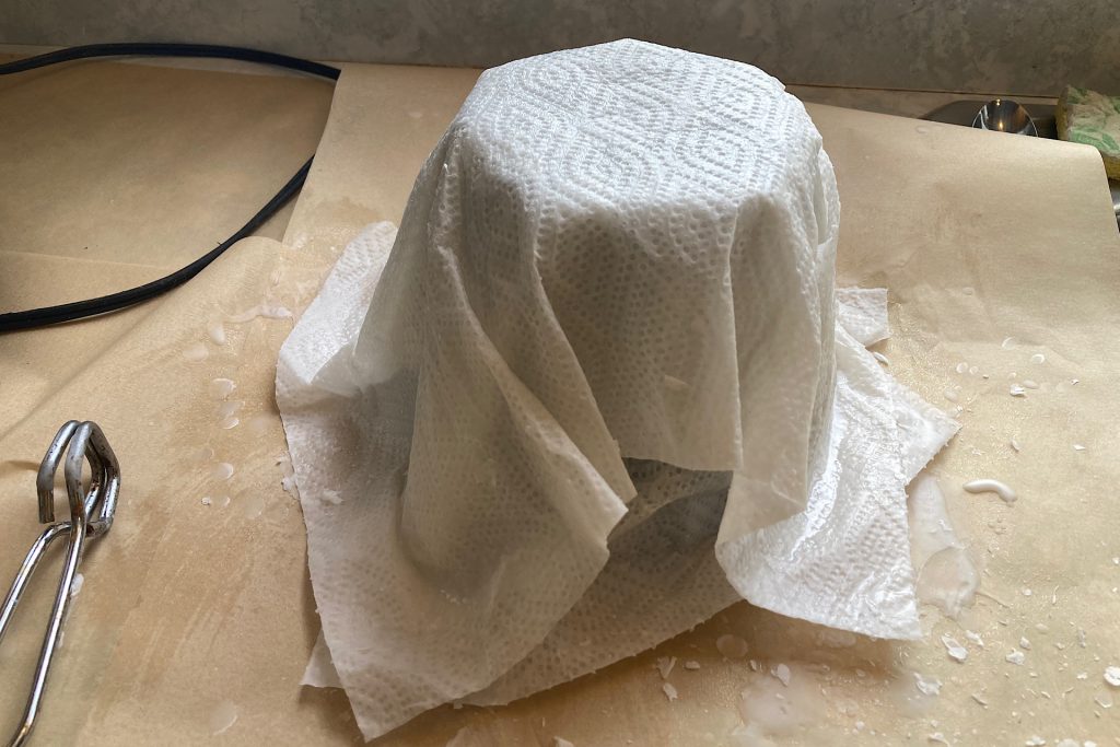 plastic pot covered with two waxed paper towel sheets