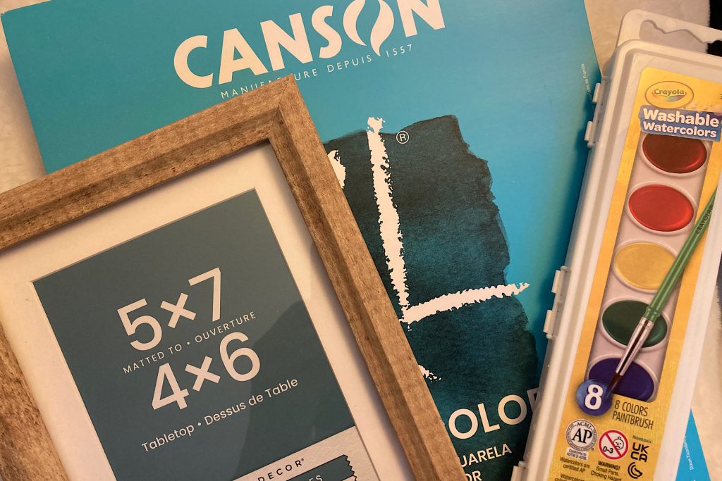 frame, watercolor pad and watercolors