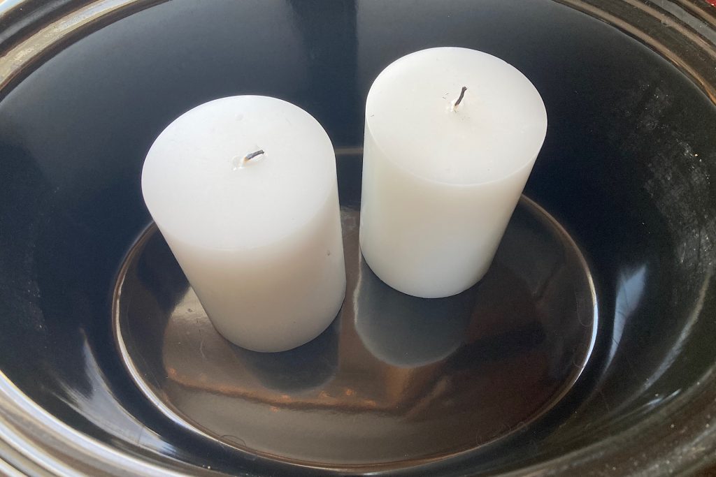 white pillar candles in crockpot for DIY paperwhite planter project