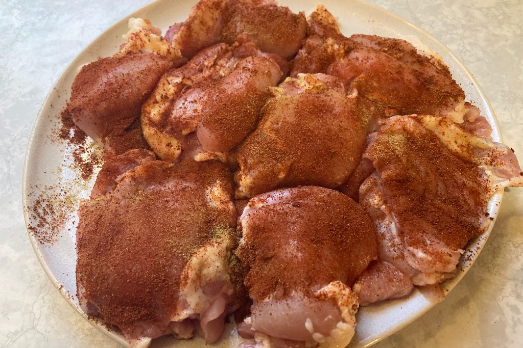 raw chicken thighs with paprika/cumin spice rub