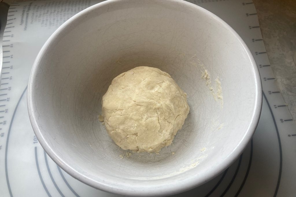 dough ball in white bowl for grandmother's peach pie recipe