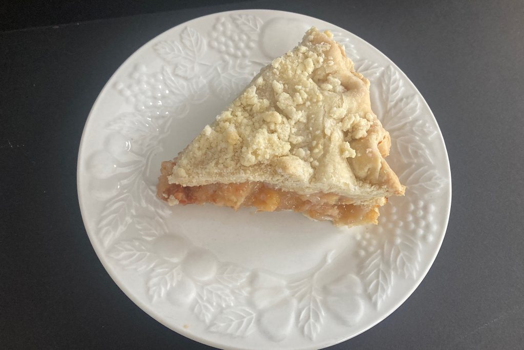 slice of peach pie on white dish