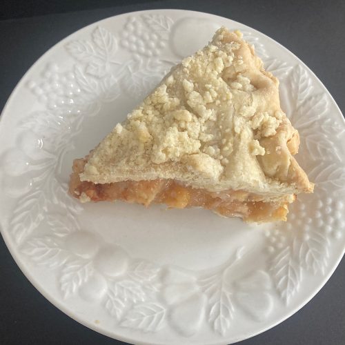 slice of peach pie on white dish