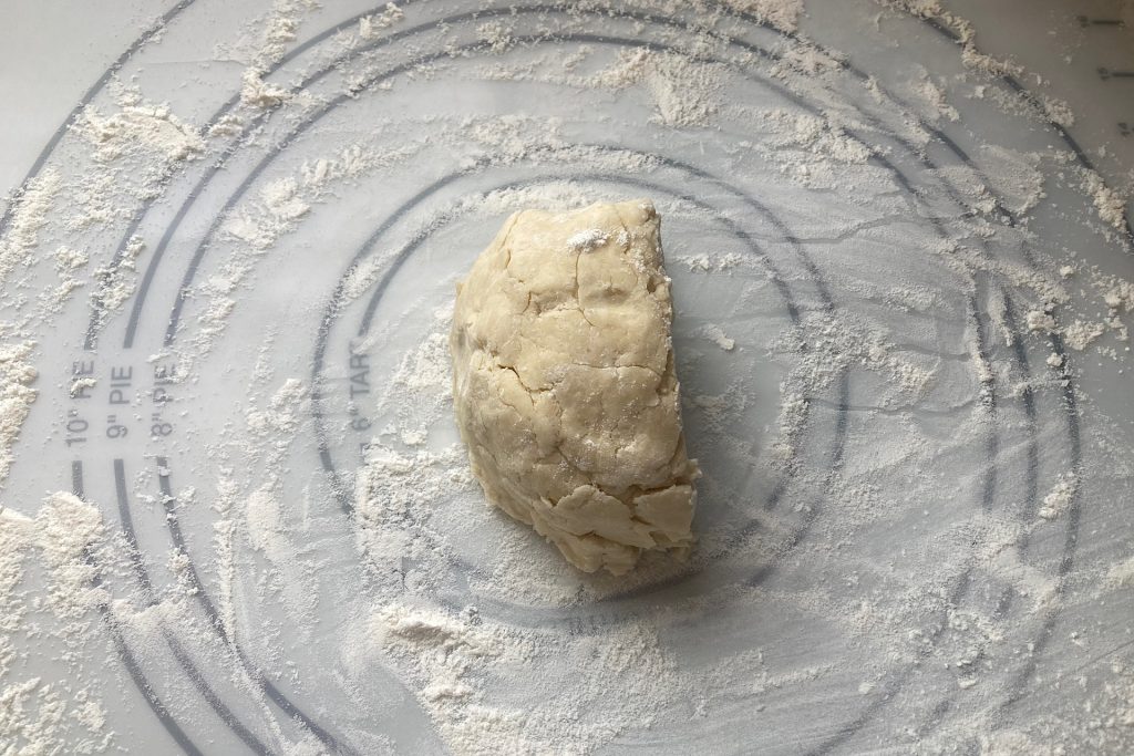 half a round of pie dough on floured mat