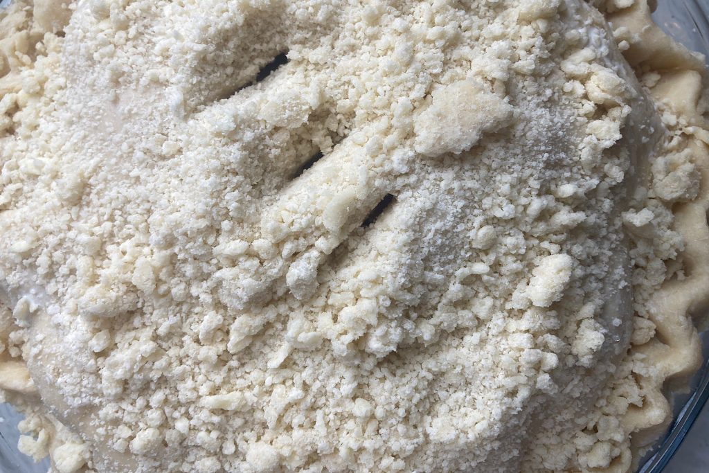 slices cut in top of raw pie dough