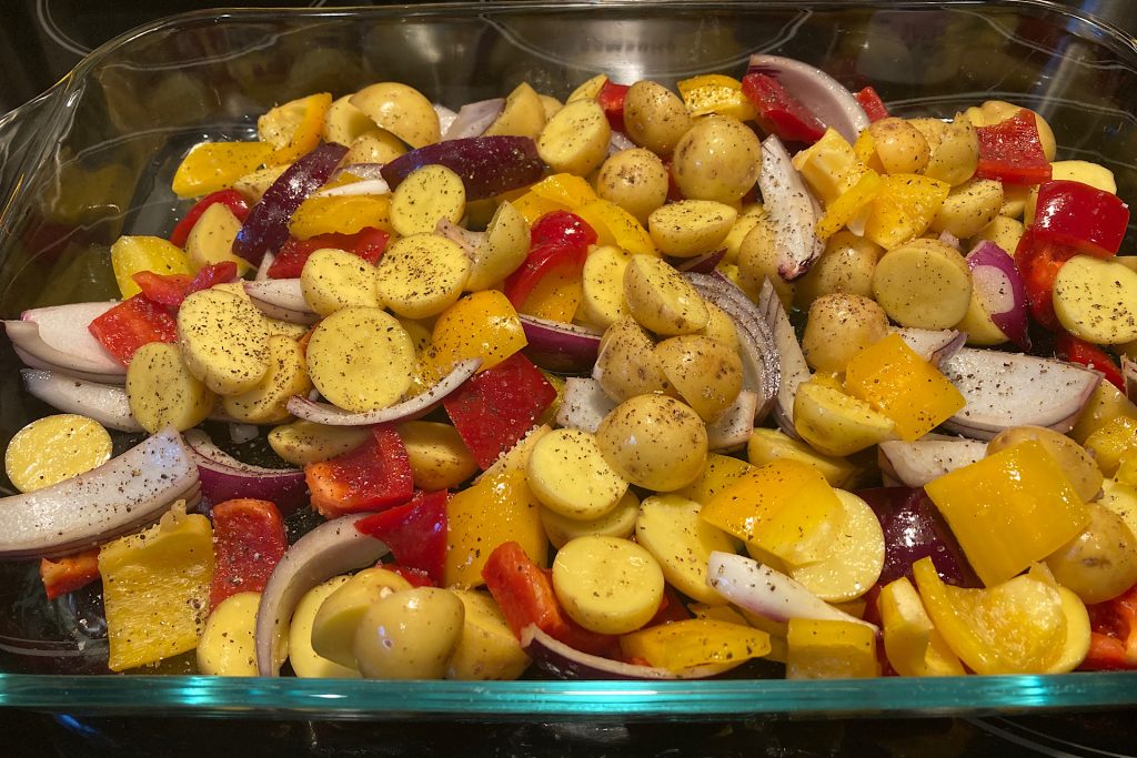 Chopped potato, bell pepper and onion for Sheet Pan Chicken Thighs Over Drip-Roasted Vegetables