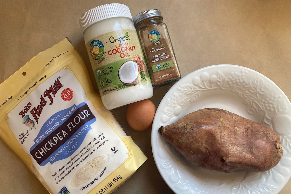 chickpea flour, coconut oil jar, ground cinnamon jar, egg, and baked sweet potato