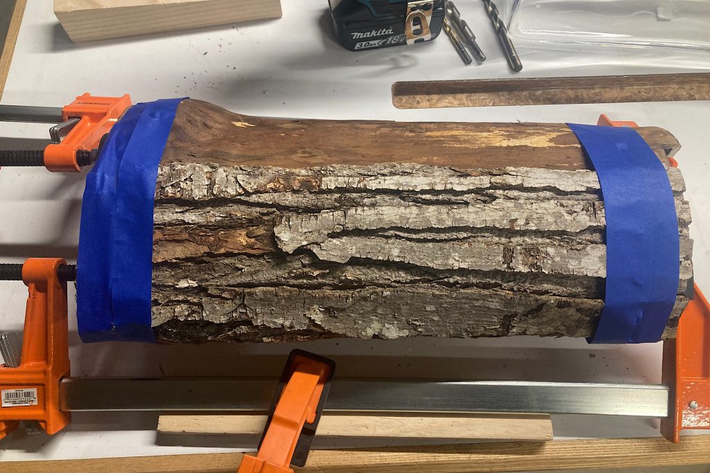 taping and clamping tree bark to drill for Woodland Flower Arrangement
