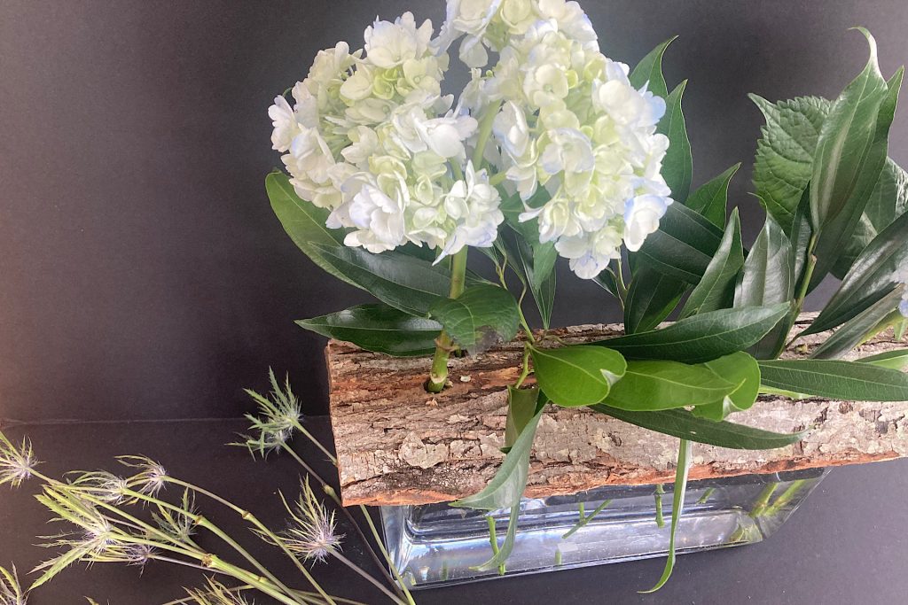 putting together woodland flower arrangement