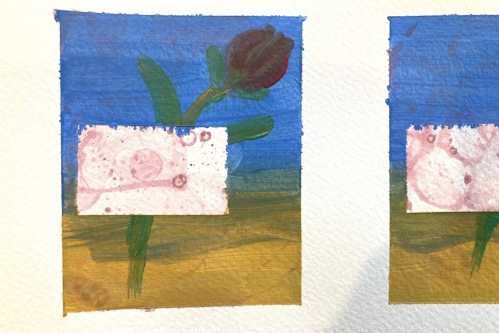 close up of artwork covered by painter's tape revealed