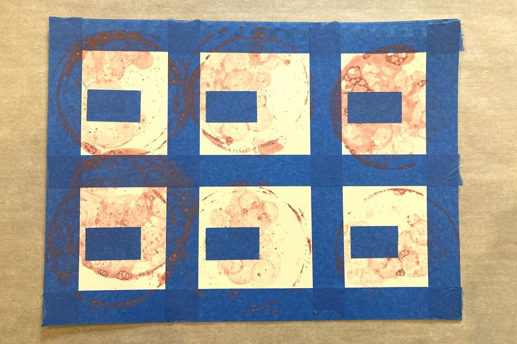 covering DIY Bubble Print Art with blue painter's tape