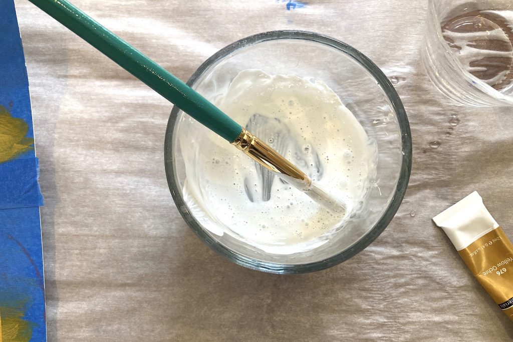 whitewash mix in glass bowl with paint brush